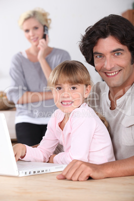 Dad and daughter using a laptop