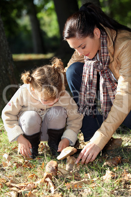 Mother and daughter picking mushrooms