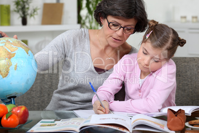 Mother teaching daughter from home