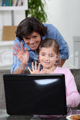mother and daughter talking with someone on the Internet
