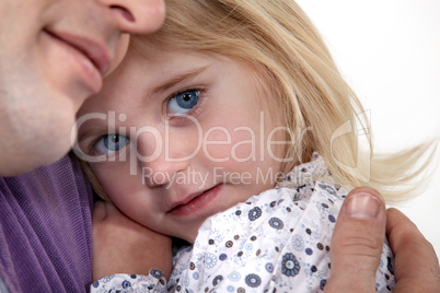 Father holding young daughter