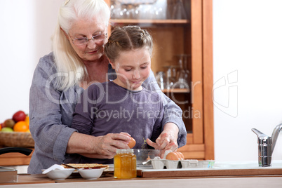 Little girl cooking with grandmother