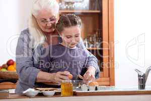 Little girl cooking with grandmother