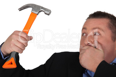 Man in suit holding hammer