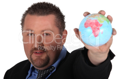 Man in suit holding globe