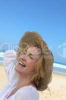Woman laughing on the beach
