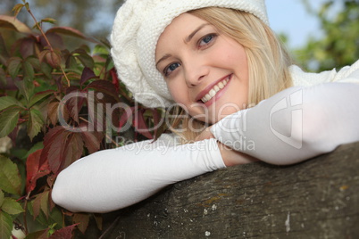 Woman leaning against tree
