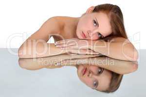 Woman lying on mirror