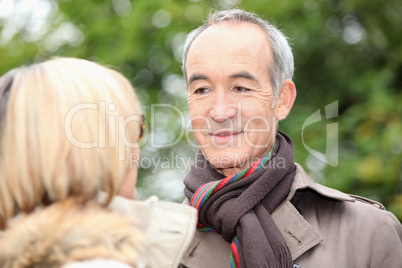 mature gentleman looking at his lady fondly
