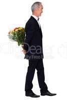 Man in an evening suit with a bouquet of flowers
