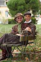 Elderly couple sat on bench