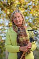 Woman raking leaves in a yard