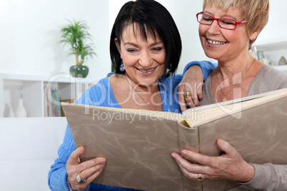 Two women looking through family photo album