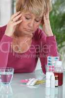 Woman sat in front of medication