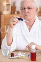 Elderly woman with a thermometer