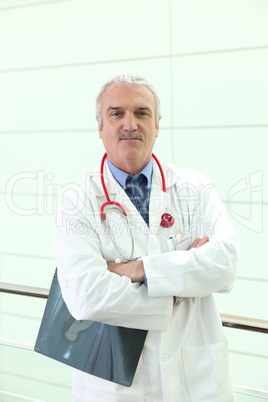 mature doctor crossing arms
