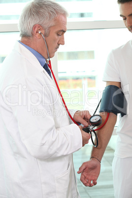 Doctor checking a patient's blood pressure