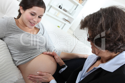 Doctor checking pregnant lady's progress