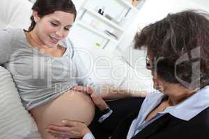 Doctor checking pregnant lady's progress