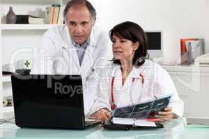 male and female doctors with laptop