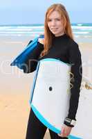 Young female surfer with bodyboard and flippers