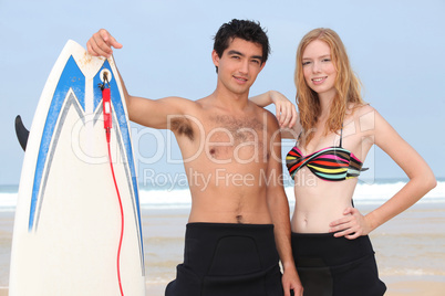 Couple with surfboard