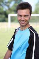 Male footballer in front of goal