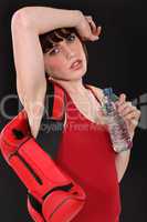 Female boxer drinking a bottle of water