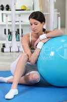 Woman sitting with an exercise ball