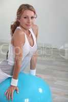 Woman balancing on inflatable gym ball