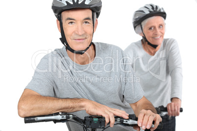 Mature couple biking.