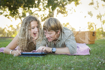 Attractive Loving Couple Using a Touch Pad Outside