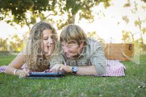 Attractive Loving Couple Using a Touch Pad Outside
