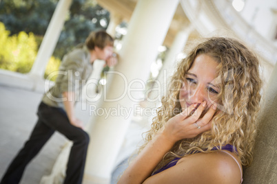 Woman Upset While Man Comtemplates in the Background