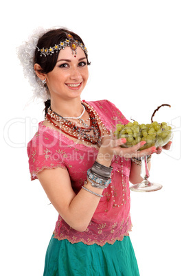 Young girl in the Indian national dress with grapes