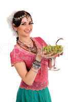 Young girl in the Indian national dress with grapes
