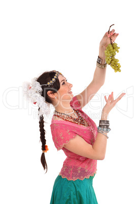 Young girl in the Indian national dress with grapes