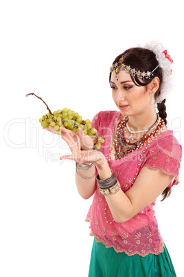 Young girl in the Indian national dress with grapes