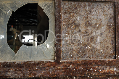 rusty factory door and smashed glass