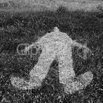 human figure outline imprinted on grass