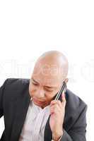 Portrait of a serious businessman talking on mobile phone over w