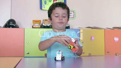Preschool Student playing toy cars in the classroom