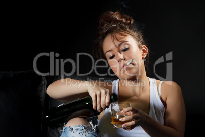 Woman smoking while pouring a drink