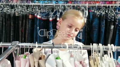 Little Girl Shopping For Clothes in Clothing Store