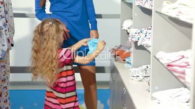 Family Shopping For Clothes in Clothing Store