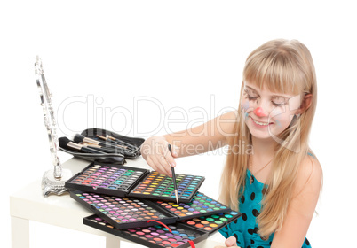 Little girl paints his face makeup