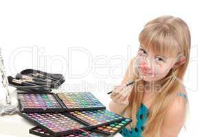 Little girl paints his face makeup