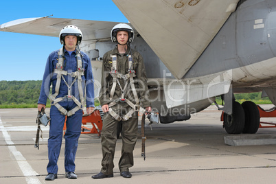 Two military pilot in a helmet near the aircraft