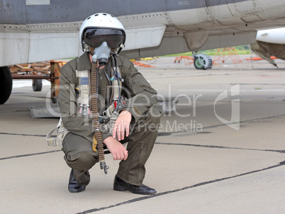 military pilot in a helmet near the aircraft