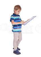 Boy writes in his diary. Isolated over white background.